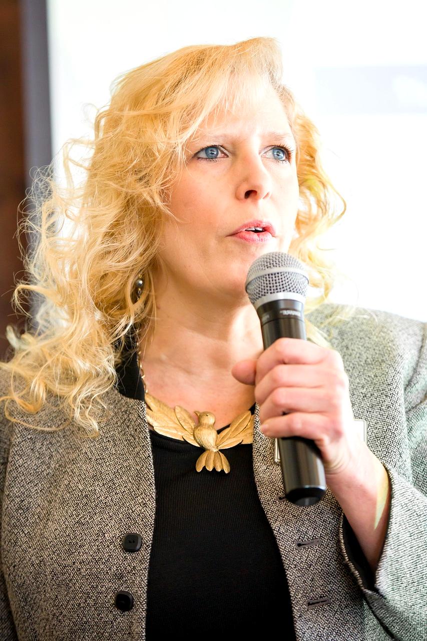 Confident speaker presenting at large professional conference with engaged audience
