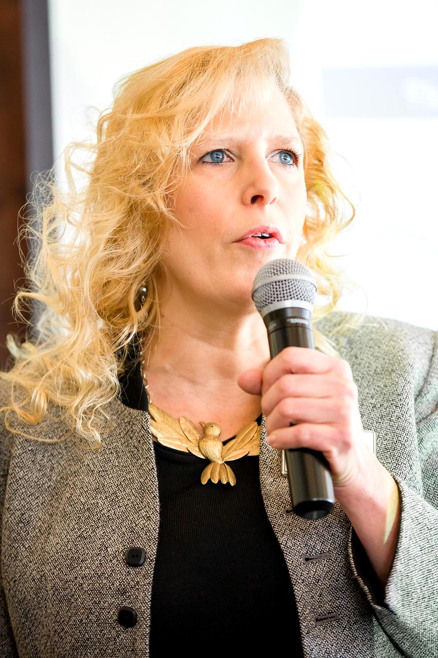 Professional speaker presenting to an engaged audience in a modern conference hall
